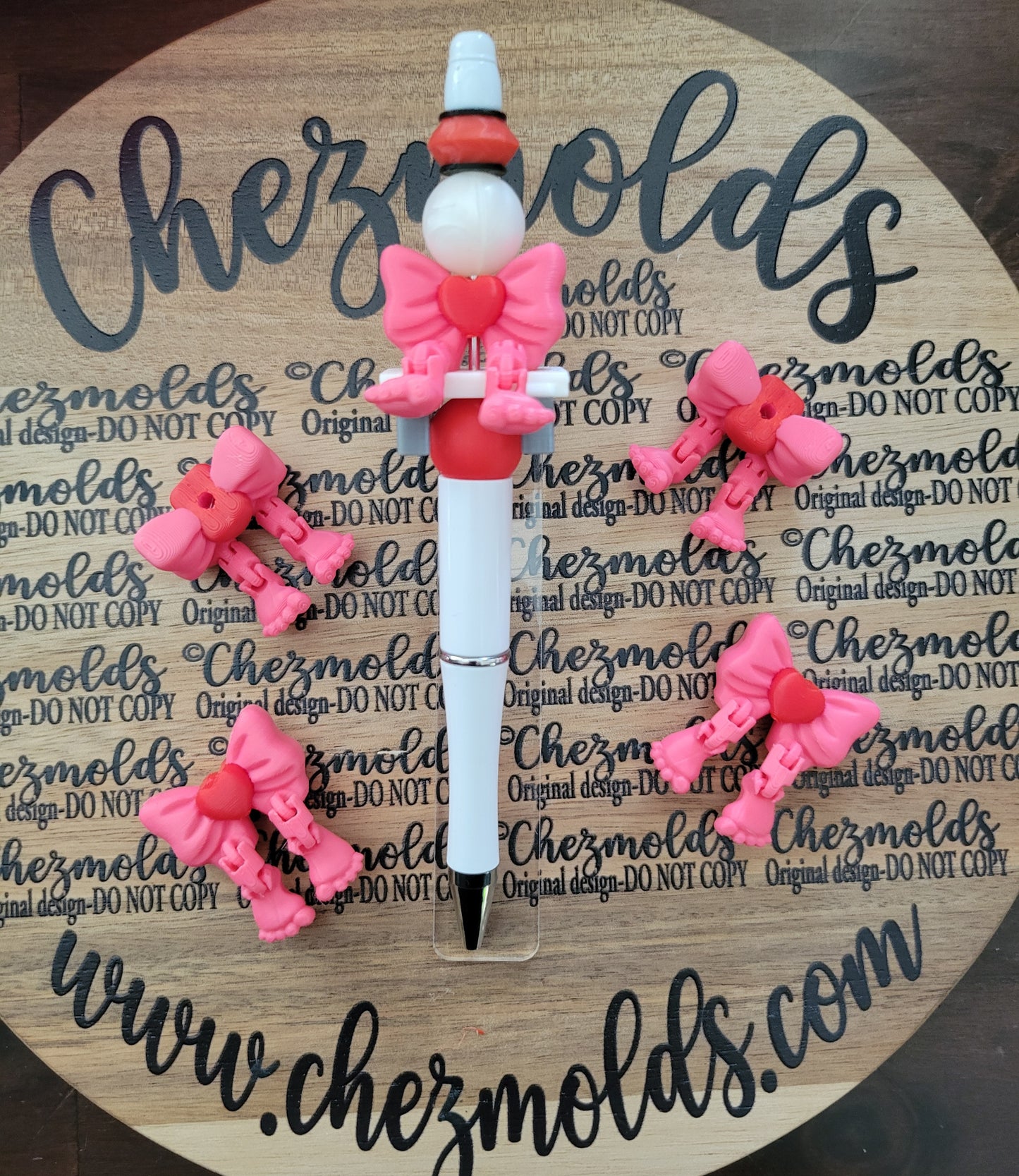 CE 3d printed focal bead- Bow kicker ( flexy feet ) pink/red